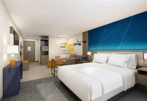 Furnished multifamily guest room with coordinated casegoods and seating
